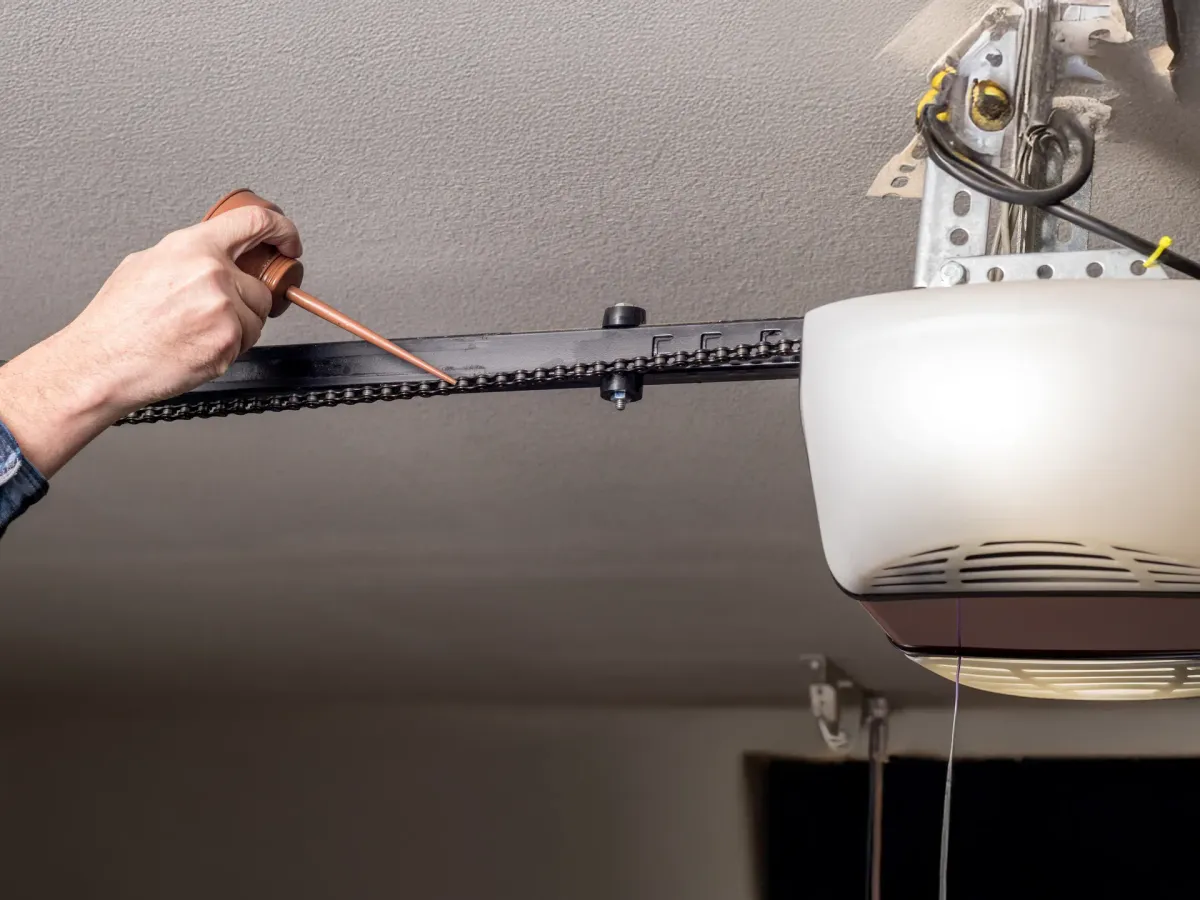 Technician working on garage door spring hardware